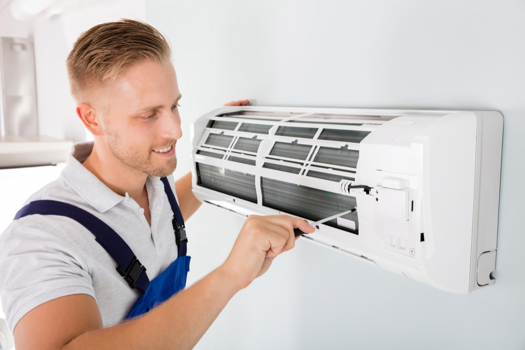 HVAC technician performing ductless air conditioning maintenance in Colorado Springs