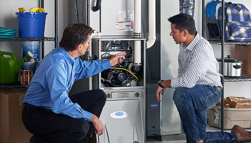 HVAC technician evaluating a furnace for repair or replacement in Colorado Springs