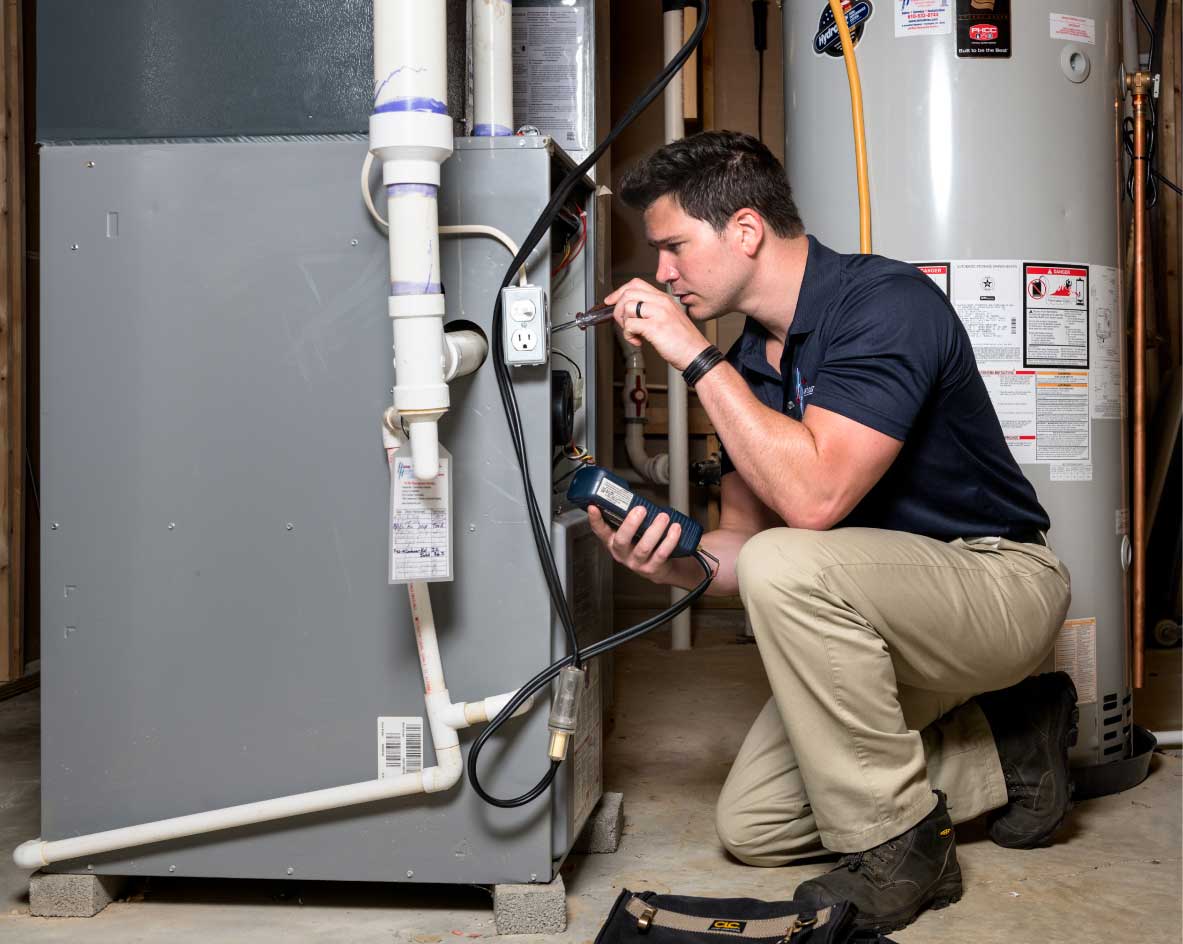 HVAC technician performing a furnace tune-up in Colorado Springs