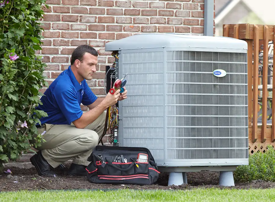 HVAC technician inspecting an outdoor air conditioning unit in Colorado Springs