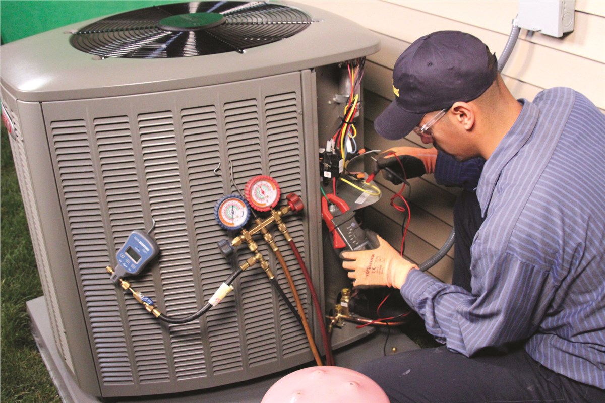 HVAC technician testing an outdoor air conditioning unit in Colorado Springs